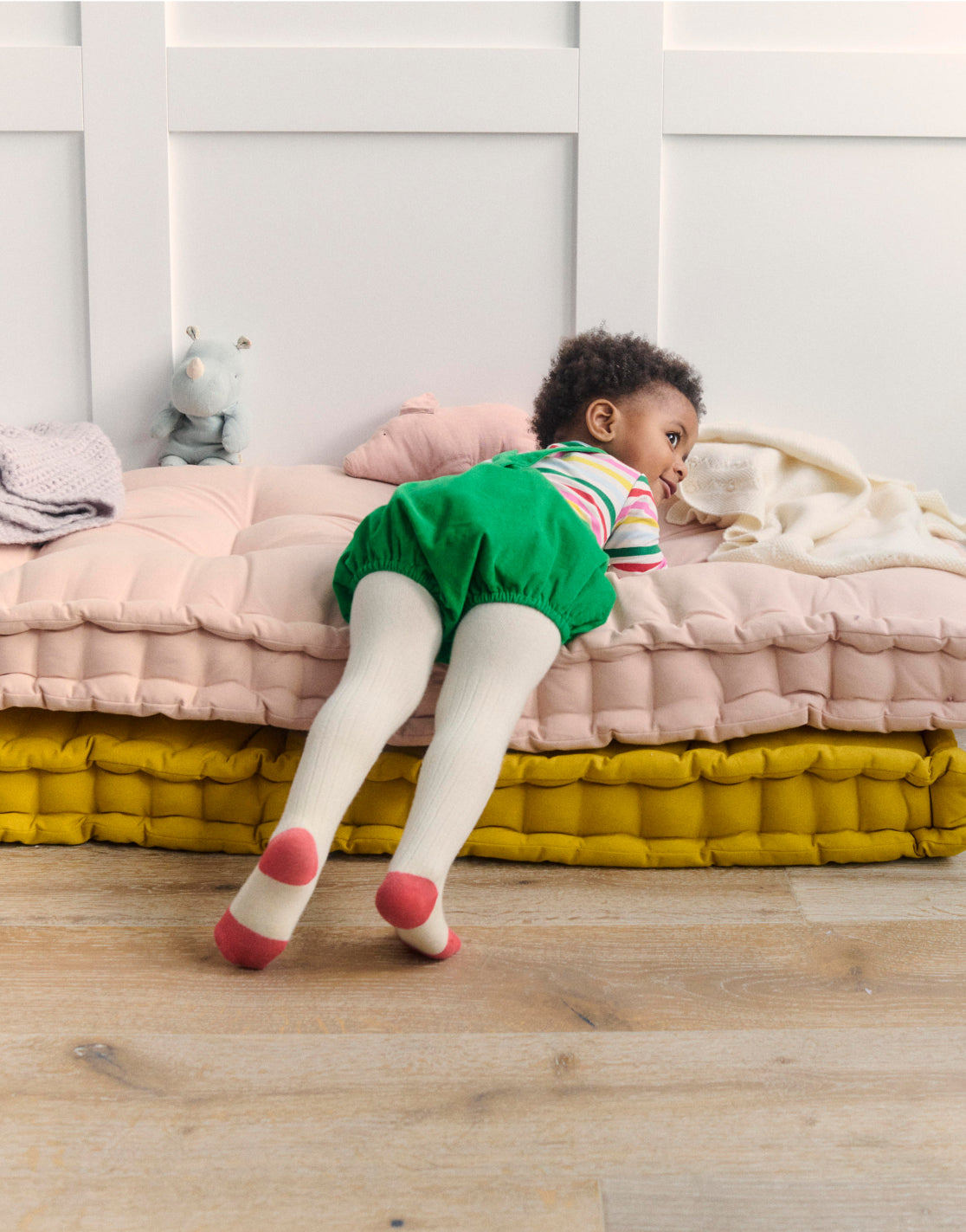 Baby laying down wearing full boden outfit