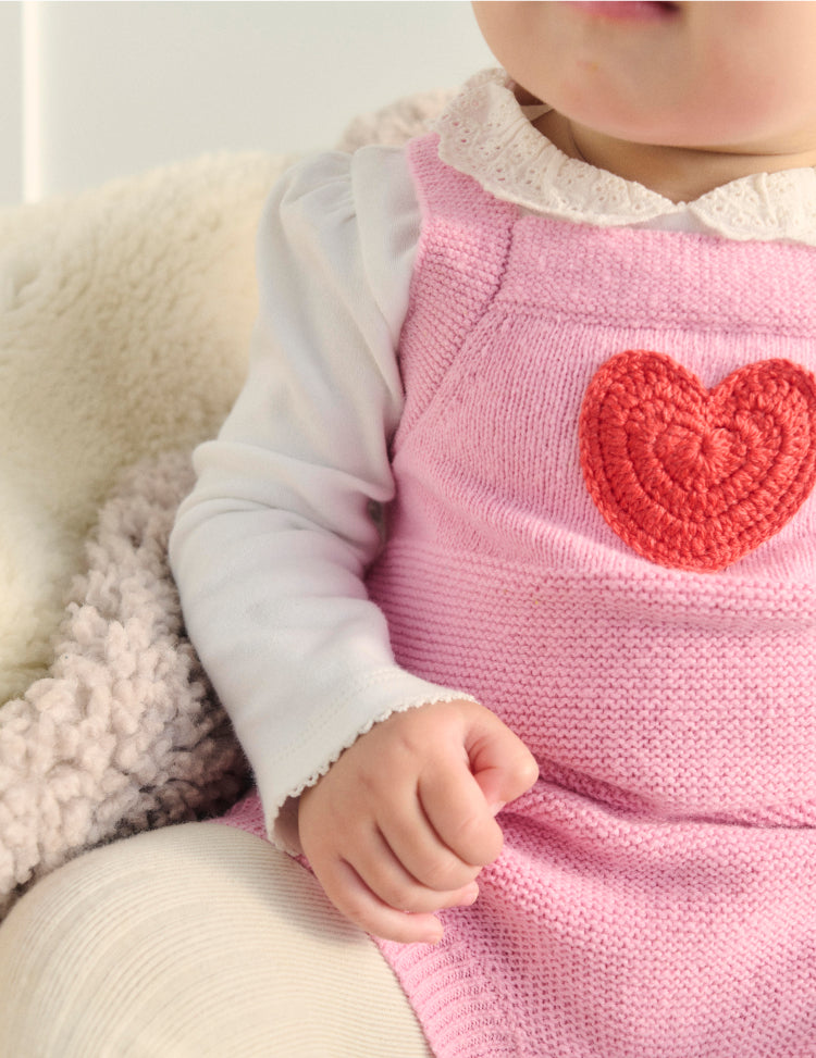 Close up of the heart detail on a baby boden knit outfit