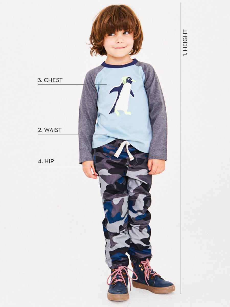 Boden boy model image with text pointing to the height, waist, chest & hip of his outfit