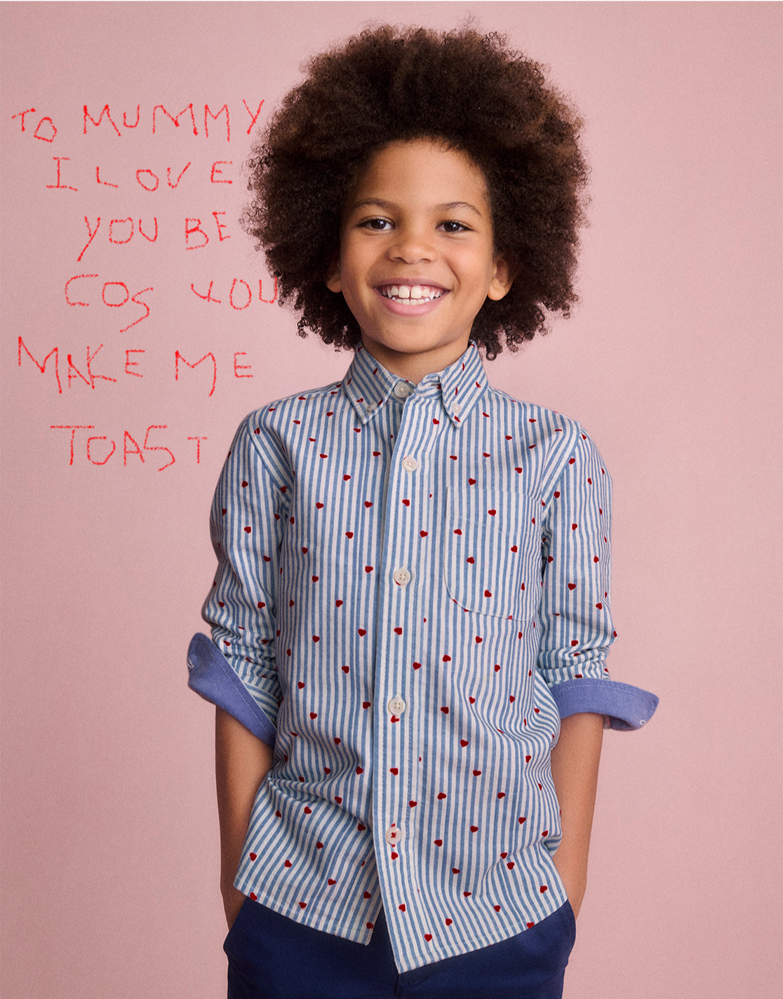 A Boy wearing a Shirt with Blue Seersucker Hearts 